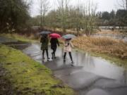 Terry McDowell, center, walks Tuesday along the Salmon Creek Greenway Trail with her daughters Marisa, left, and Chloe, 16, in Vancouver.