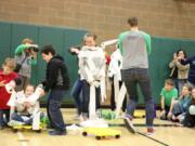 Battle Ground: Tukes Valley Middle School students race to see who can wrap their classmates up as snowmen the fastest during an assembly to celebrate the school’s successful donation drive in support of the district’s Family and Community Resource Center.