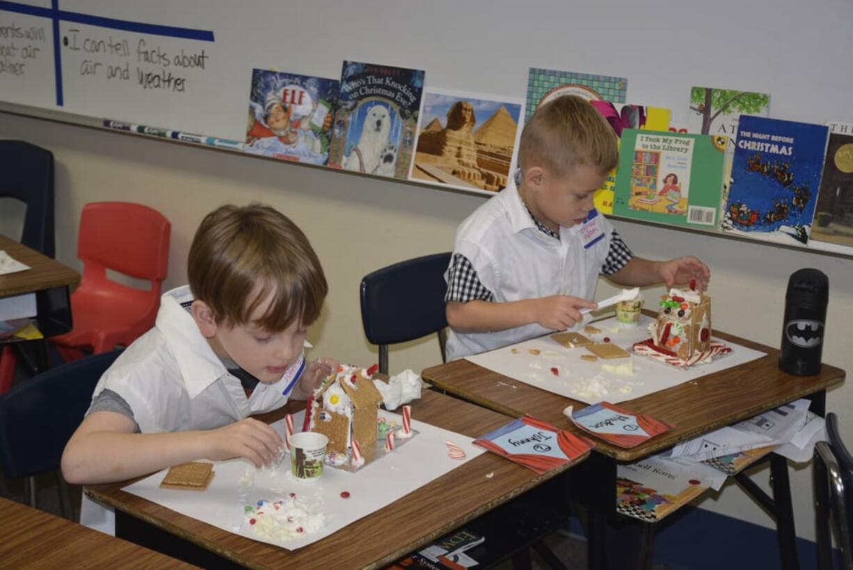 Washougal: Gause Elementary School first-graders Johnny Bradley, left, and Hudson Weaver build gingerbread houses for a lesson on the scientific method.