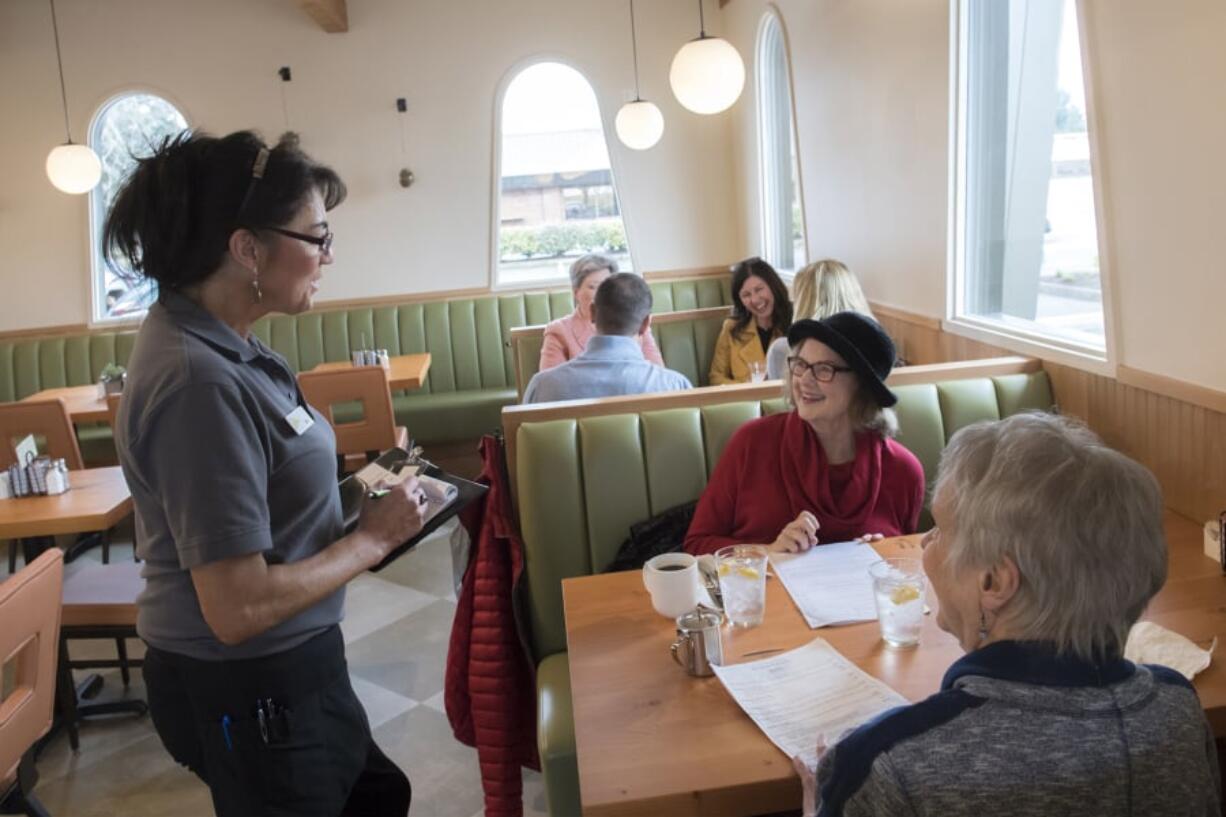 Dea Taylor, from left, takes a lunch order from Carolyn Walz and Anne Garlinghouse during the lunch rush Tuesday at The Diner Vancouver, a new restaurant owned by Meals on Wheels People that had a soft opening Feb. 11. “We have so many repeat customers already,” Taylor said.