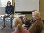 Instructor Rob Nyczaj watches former American Sign Language teacher Doug Kennedy discuss his afternoon Sunday during a conversation circle at the Vancouver Community Library.