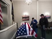 Carole Green, sister of U.S. Navy Musician Second Class Francis E. Dick, and her son, Mike Green, stand with Dick’s casket at Vancouver Funeral Chapel after meeting his body at Portland International Airport on Feb. 9. Green last saw her brother when she was 3 years old.