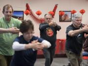 David Snyder, from left, Nicole Hackman, Tom McNicholas and Bruce Hall of Taoist Tai Chi Society give a tai chi performance for the crowd during the Lunar New Year celebration at Washington State University Vancouver on Wednesday afternoon, Feb. 20, 2019. "It's a moving meditation so it's really relaxing," Hackman said. 2019 is the Year of the Pig.