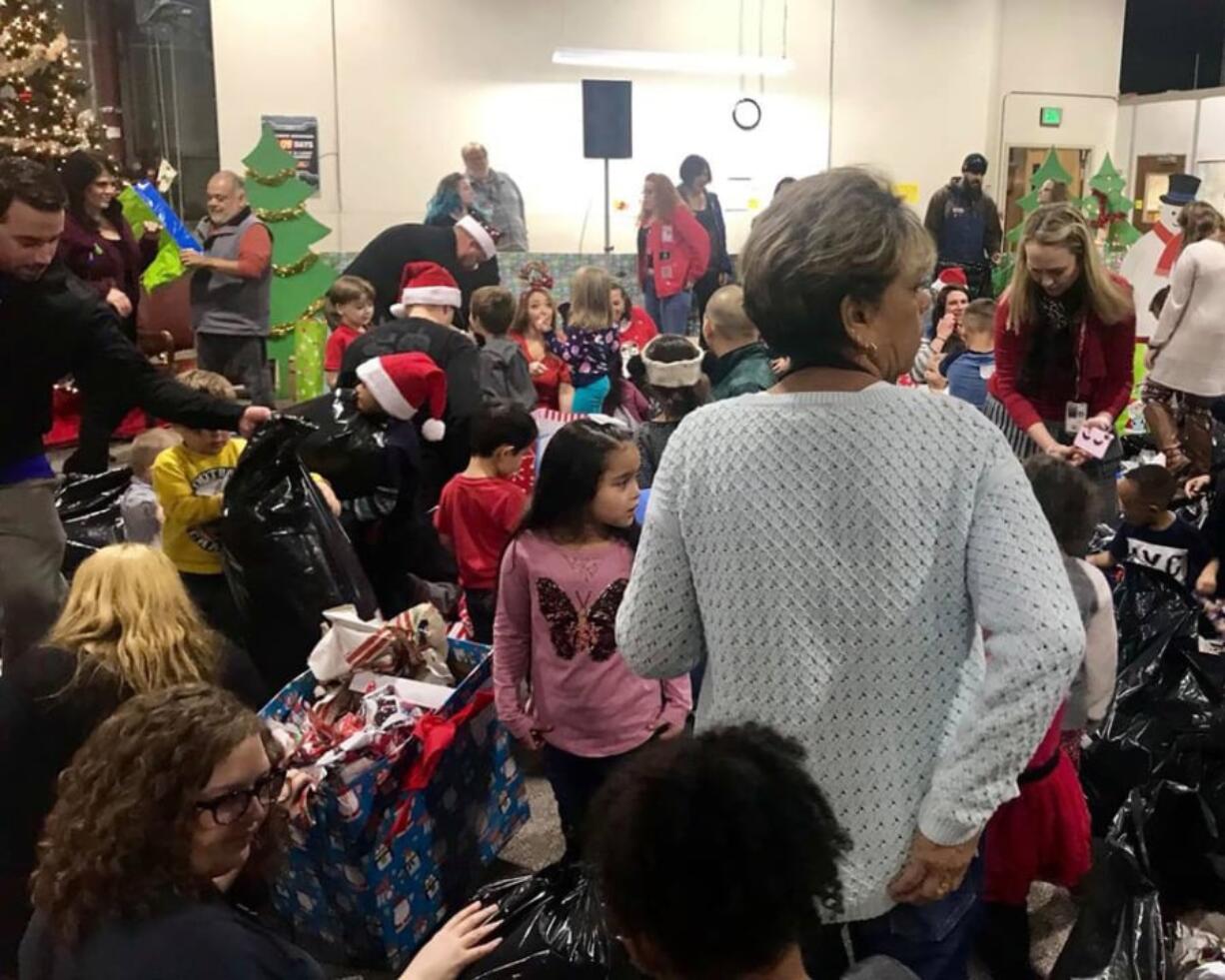 Evergreen Highlands: Kids from Learning Avenues Child Care unwrap presents from the Associates, an organization of employees at the Bonneville Power Administration, which has sponsored the day care center for more than 30 years.