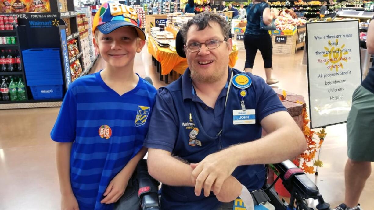 John Combs, a greeter at the Walmart Supercenter at 430 S.E. 192nd Ave. in Vancouver, welcomes his nephew to the store.