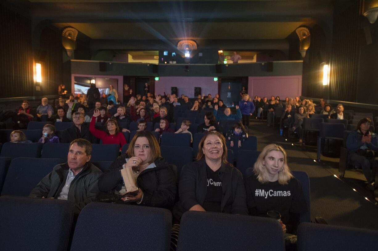 Camas city administrator Pete Capell, from left, joins Camas City Council member Deanna Rusch, Camas Mayor Shannon Turk and her daughter, Lanie Turk, as they wait for results at Liberty Theatre in Camas on Tuesday. Camas was one of six finalists in the running for the next season of online show, “Small Business Revolution.” The town of Searcy, Ark., was selected for the show.