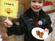 Five Corners: Sunset Elementary School student Brandon Martin with some of the sweet potatoes from the most recent Harvest of the Month at Evergreen Public Schools.