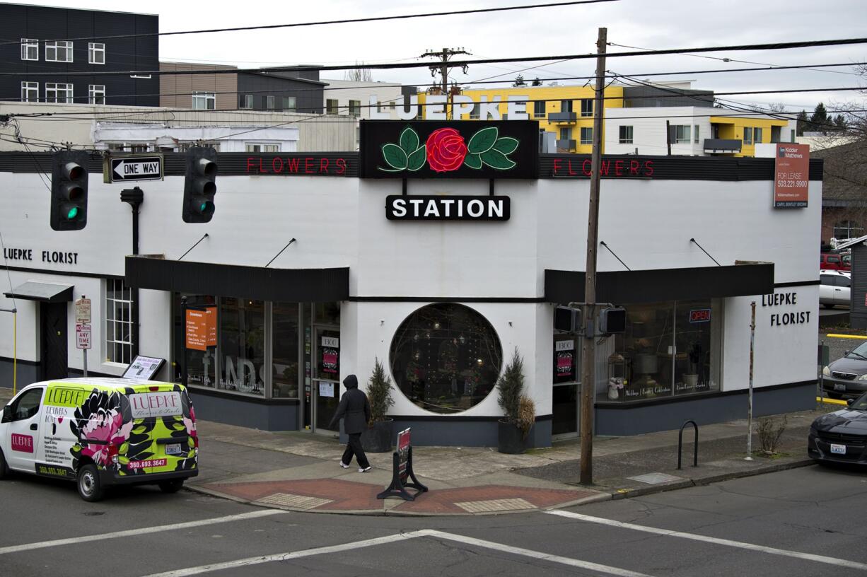 A pedestrian walks past Luepke Flowers and Finds on Wednesday afternoon, Feb. 27, 2019, which has announced it is set to close on Feb. 28.