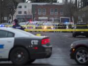 Crime scene tape and police cars are visible at the scene of the shooting near the intersection of West 12th Street and Jefferson Street in downtown Vancouver on Thursday afternoon, Feb. 28, 2019.