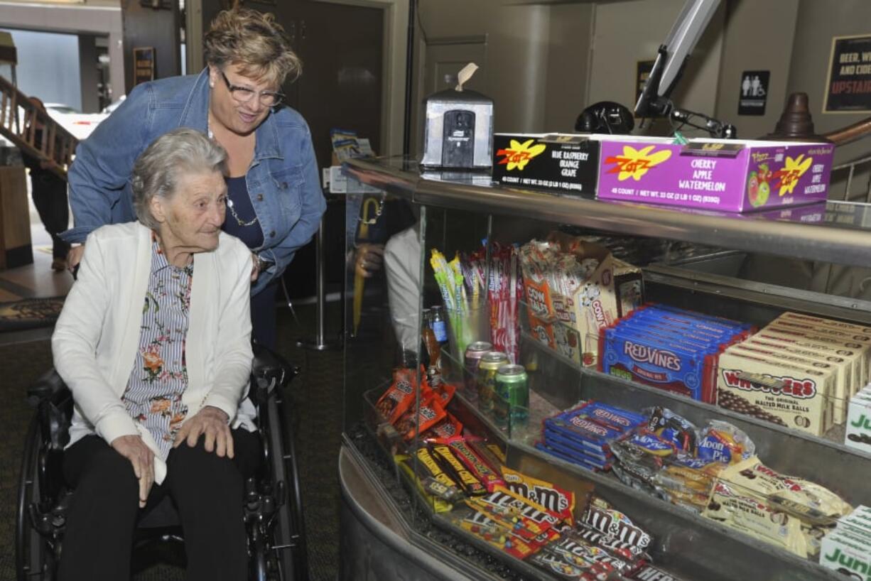 Longtime manager Popcorn Betty, aka Bettyan Howard, returned last April to the Kiggins Theatre for a 90th birthday celebration in her honor. Here, daughter Nancy Lecouris and Howard check out the concession stand. Howard died Feb. 22.