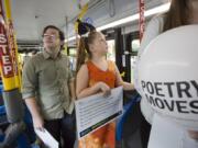 Poets on wheels: In this photo from summer 2016, ninth-grade poet Cole Beckwith of Fort Vancouver High School (left) and third-grade poet Breanna Kelley of Riverview Elementary School celebrate literature on a C-Tran bus.