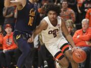 Oregon State's Ethan Thompson (5) skirts past California's Justice Sueing (10) during the second half of an NCAA college basketball game in Corvallis, Ore., Saturday, Feb. 9, 2019. Oregon State won, 79-71.