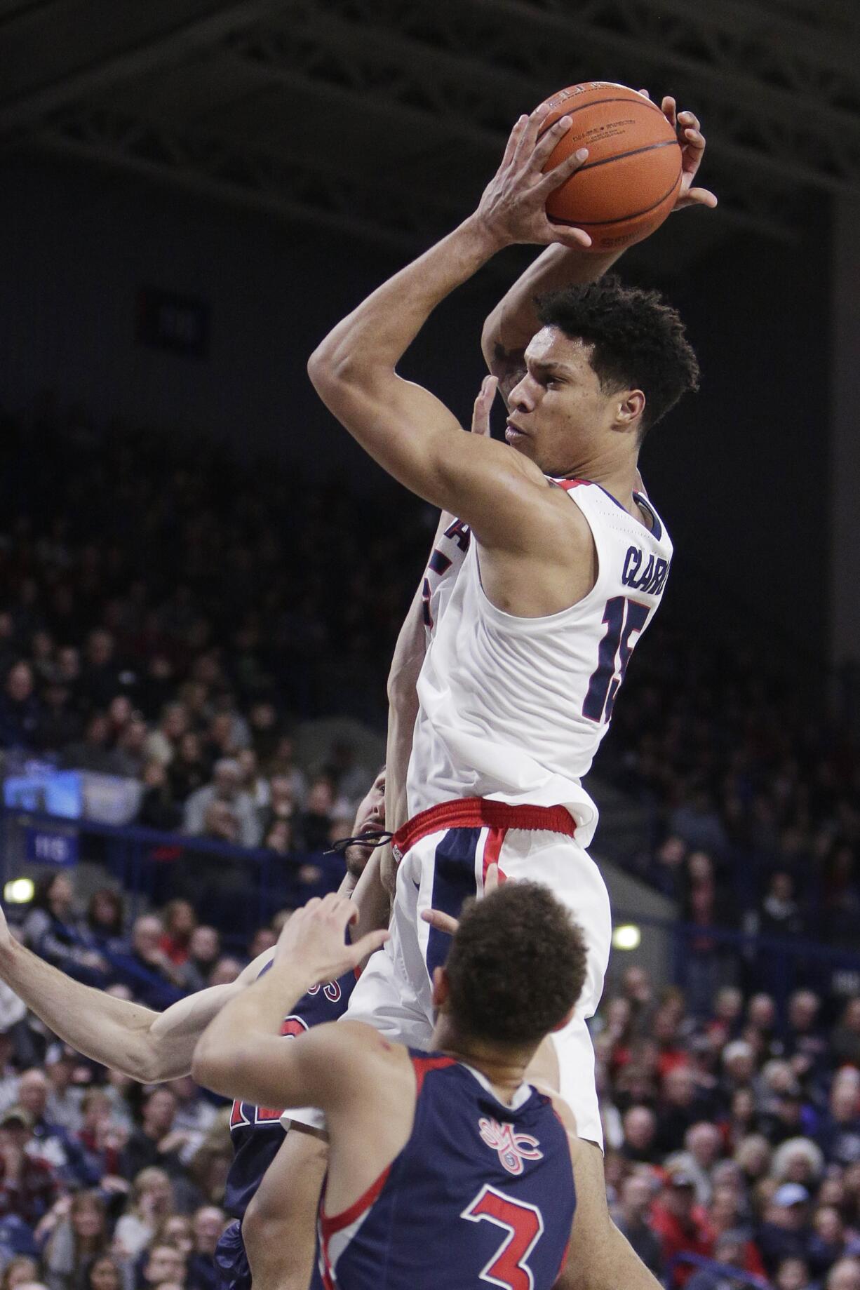 Gonzaga forward Brandon Clarke, top, grabs a rebound over Saint Mary's guard Jordan Ford during the second half of an NCAA college basketball game in Spokane, Wash., Saturday, Feb. 9, 2019. Gonzaga won 94-46.