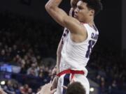 Gonzaga forward Brandon Clarke, top, grabs a rebound over Saint Mary's guard Jordan Ford during the second half of an NCAA college basketball game in Spokane, Wash., Saturday, Feb. 9, 2019. Gonzaga won 94-46.