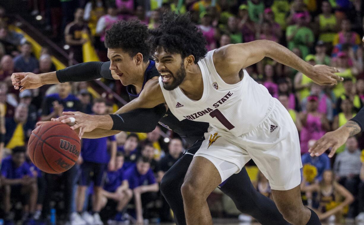 Arizona State's Remy Martin, right, reaches the ball with Washington's Matisse Thybulle during the second half of an NCAA college basketball game Saturday, Feb. 9, 2019, in Tempe, Ariz. Arizona State won 75-63.