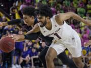 Arizona State's Remy Martin, right, reaches the ball with Washington's Matisse Thybulle during the second half of an NCAA college basketball game Saturday, Feb. 9, 2019, in Tempe, Ariz. Arizona State won 75-63.