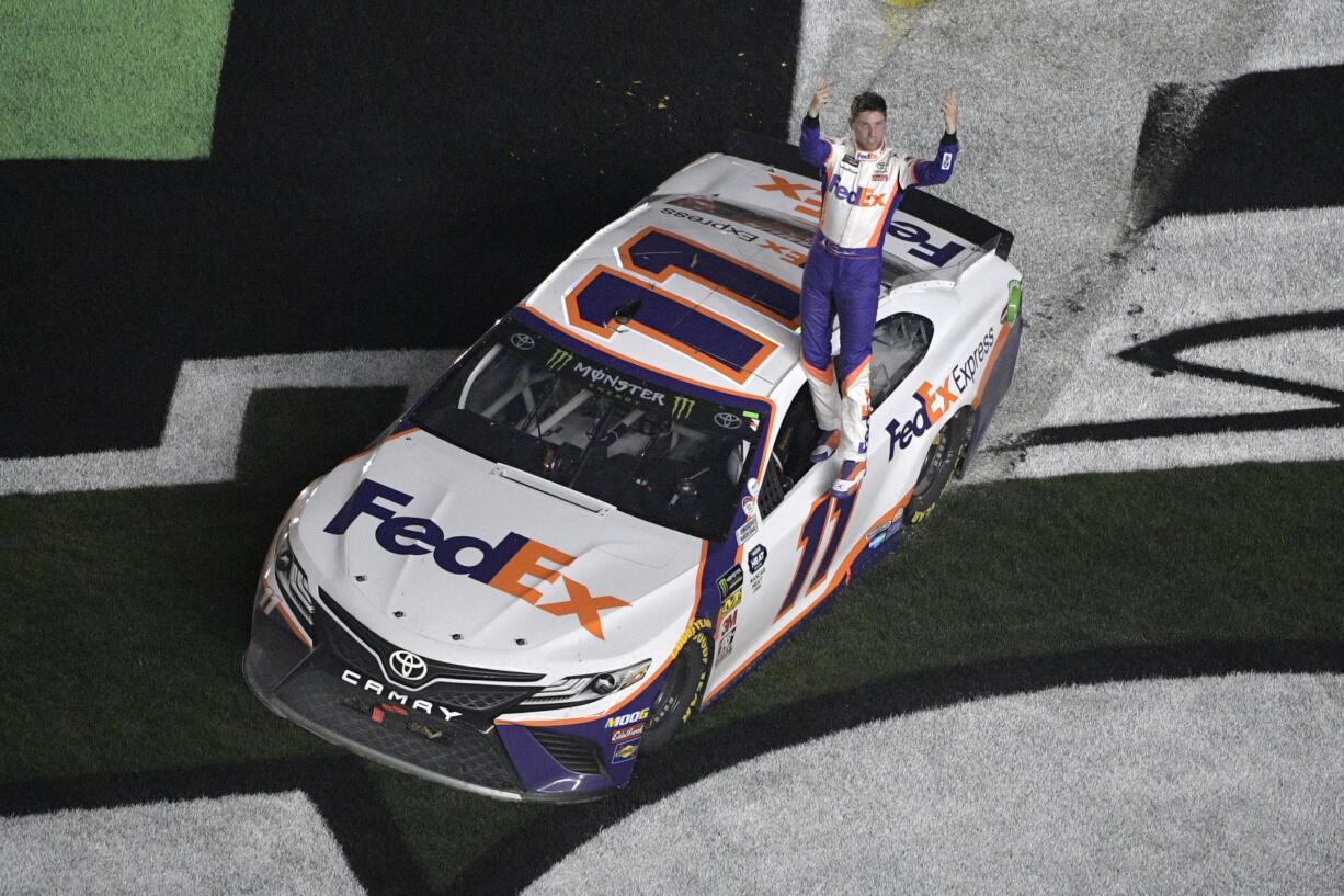 Denny Hamlin (11) celebrates after winning the NASCAR Daytona 500 auto race at Daytona International Speedway Sunday, Feb. 17, 2019, in Daytona Beach, Fla. (AP Photo/Phelan M.