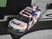 Denny Hamlin (11) celebrates after winning the NASCAR Daytona 500 auto race at Daytona International Speedway Sunday, Feb. 17, 2019, in Daytona Beach, Fla. (AP Photo/Phelan M.