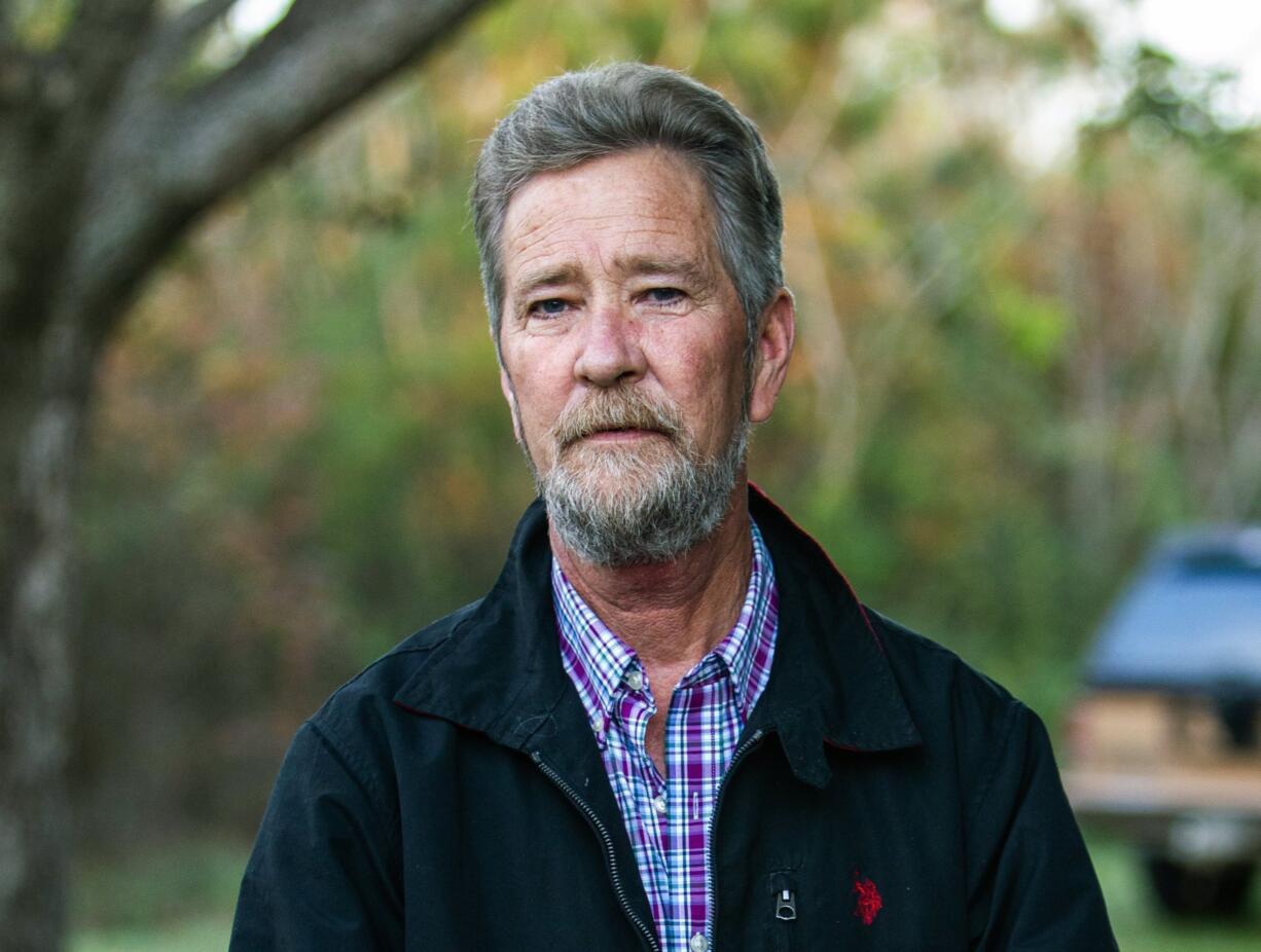 FILE - In this Dec. 5, 2018 file photo, Leslie McCrae Dowless Jr. poses for a portrait outside of his home in Bladenboro, N.C. The North Carolina political operative at the center of a ballot fraud scandal is facing criminal charges for his activities in the 2016 elections and the Republican primary in 2018. Wake County District Attorney Lorrin Freeman said Wednesday, Feb. 27, 2019, that Dowless was arrested after grand jury indictments alleging illegal possession of absentee ballots and obstruction of justice.