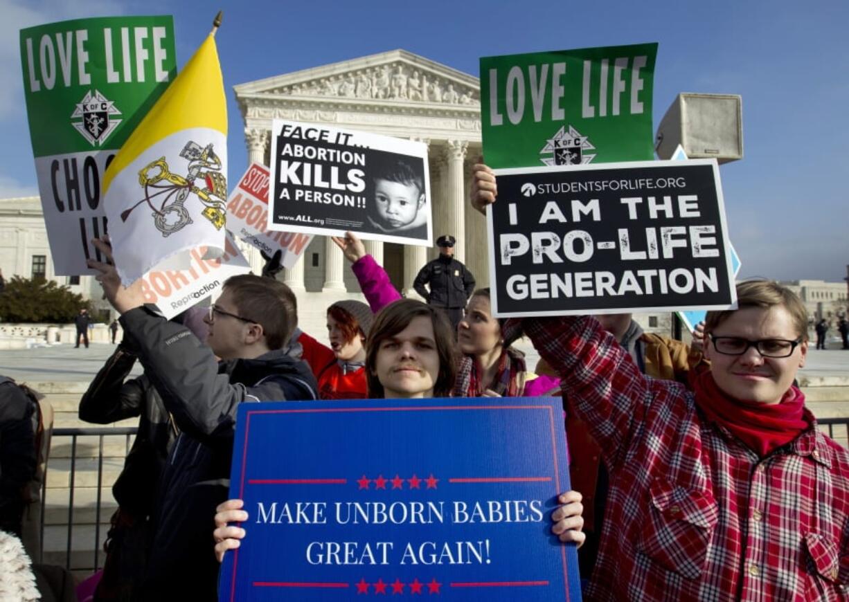 FILE - In this Friday, Jan. 18, 2019 file photo, anti-abortion activists protest outside of the U.S. Supreme Court, during the March for Life in Washington. President Trump’s call for a ban on late-term abortions is unlikely to prevail in Congress, but Republican legislators in several states are pushing ahead with tough anti-abortion bills of their own that they hope can pass muster with the reconfigured U.S. Supreme Court.