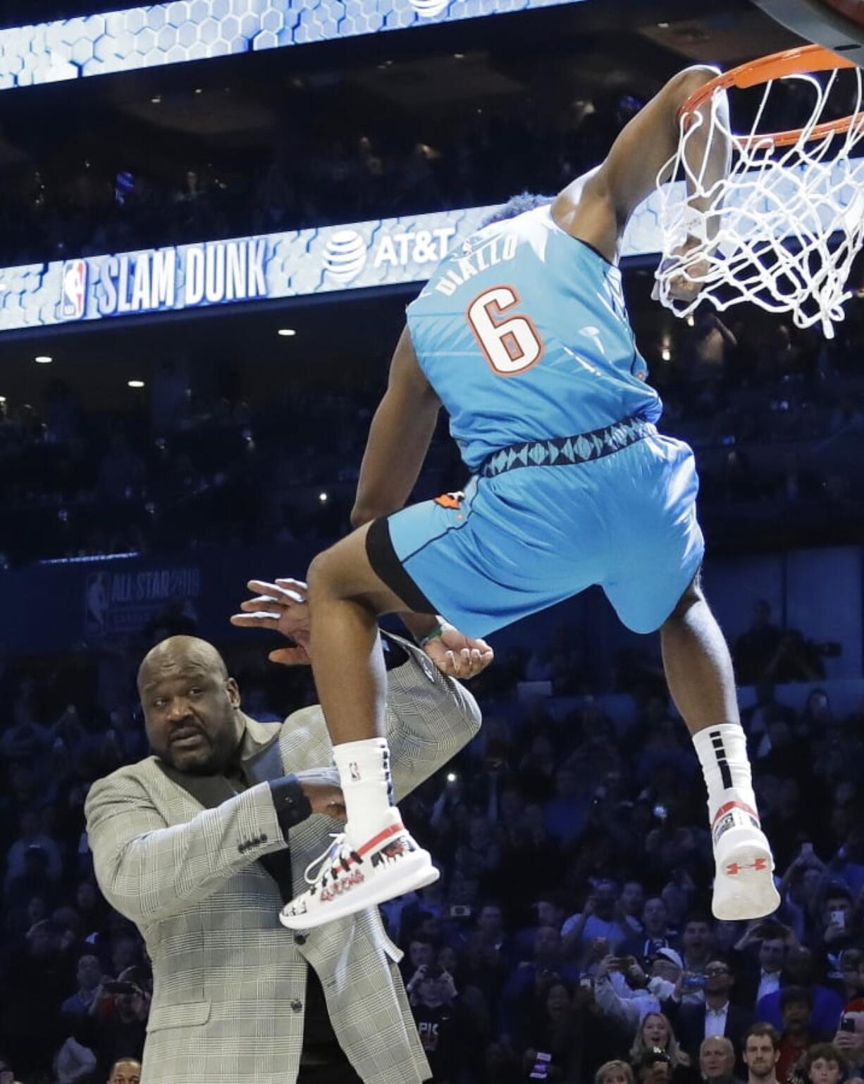 Oklahoma City Thunder Hamidou Diallo leaps over former NBA player Shaquille O’Neal during the NBA All-Star Slam Dunk contest, Saturday, Feb. 16, 2019, in Charlotte, N.C. Diallo won the contest.