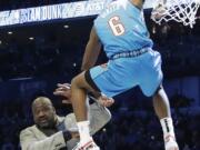 Oklahoma City Thunder Hamidou Diallo leaps over former NBA player Shaquille O’Neal during the NBA All-Star Slam Dunk contest, Saturday, Feb. 16, 2019, in Charlotte, N.C. Diallo won the contest.