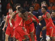 Arizona’s Brandon Randolph, left, and Brandon Williams, right, celebrate with Devonaire Doutrive, center, after Doutrive scored in the final second of the game, securing the win over Oregon State during an NCAA college basketball game in Corvallis, Ore., Thursday, Feb. 28, 2019. Arizona won 74-72.