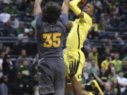 Oregon’s Louis King, right, shoots over Arizona State’s Taeshon Cherry during the second half of an NCAA college basketball game Thursday, Feb. 28, 2019, in Eugene, Ore.