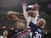 Gonzaga guard Zach Norvell Jr., top, shoots over BYU guard TJ Haws (30) during the first half of an NCAA college basketball game in Spokane, Wash., Saturday, Feb. 23, 2019.