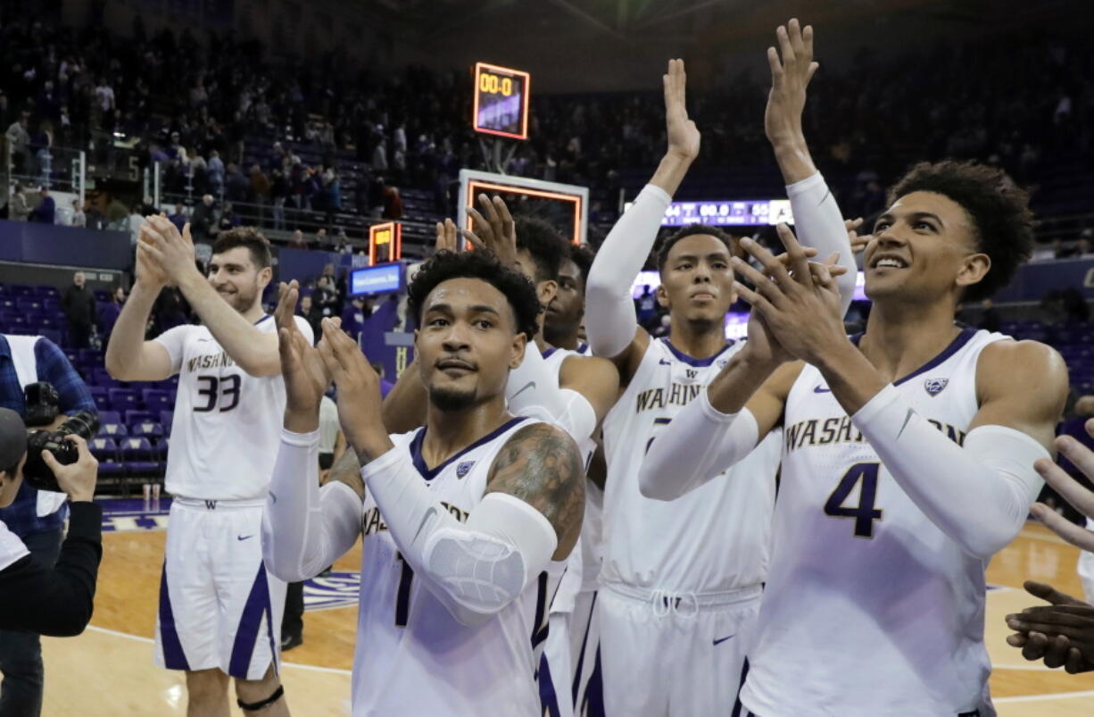 Washington’s Sam Timmins (33), David Crisp (1), Dominic Green and Matisse Thybulle (4) celebrate in front of the student section after the team’s NCAA college basketball game against Colorado, Saturday, Feb. 23, 2019, in Seattle. Washington won 64-55. (AP Photo/Ted S.