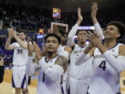 Washington’s Sam Timmins (33), David Crisp (1), Dominic Green and Matisse Thybulle (4) celebrate in front of the student section after the team’s NCAA college basketball game against Colorado, Saturday, Feb. 23, 2019, in Seattle. Washington won 64-55. (AP Photo/Ted S.