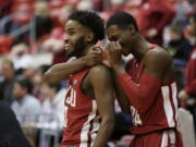 Washington State guard Ahmed Ali, left, and guard Viont'e Daniels celebrate during the second half of the team's NCAA college basketball game against Colorado in Pullman, Wash., Wednesday, Feb. 20, 2019. Washington State won 76-74.