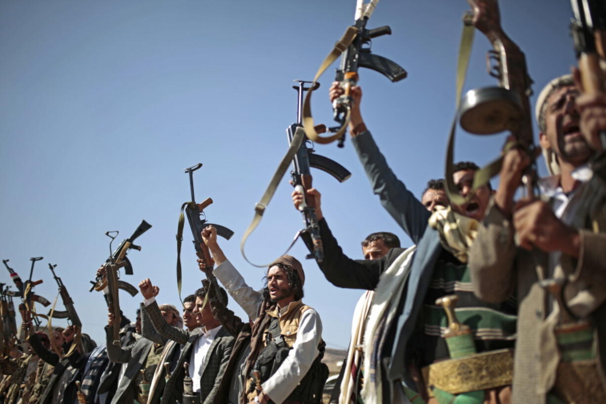 Tribesmen loyal to Houthi rebels hold up their weapons at a gathering to show support for peace talks Dec. 13 in Sanaa, Yemen. The U.S. House passed a resolution to force the Trump administration to withdraw U.S. troops from involvement in Yemen.