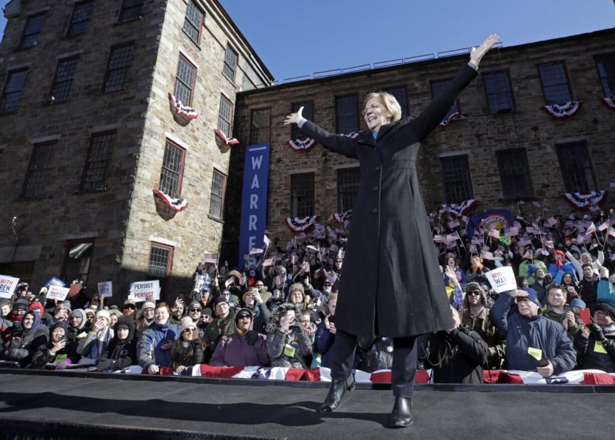 U.S. Sen. Elizabeth Warren, D-Mass., acknowledges cheers as she takes the stage during an event to formally launch her presidential campaign on Saturday in Lawrence, Mass.