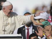 Pope Francis blesses a boy during a Mass at the Sheikh Zayed Sports City in Abu Dhabi, United Arab Emirates, Tuesday, Feb. 5, 2019. Francis travelled to Abu Dhabi to participate in a conference on inter religious dialogue sponsored the Emirates-based Muslim Council of Elders, an initiative that seeks to counter religious fanaticism by promoting a moderate brand of Islam.