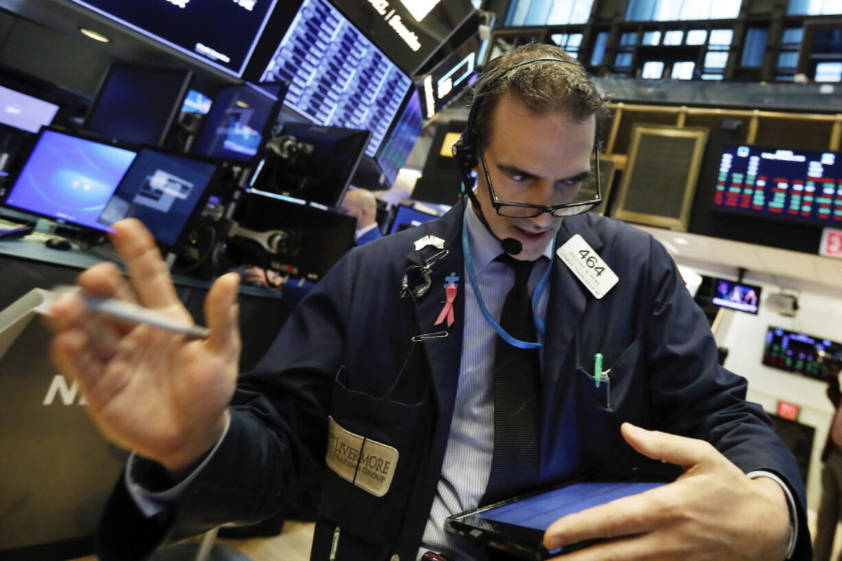 Trader Gregory Rowe works on the floor of the New York Stock Exchange, Friday, Feb. 8, 2019. Stocks are opening lower on Wall Street as a mixed bag of earnings reports didn’t inspire investors to get back to buying stocks.