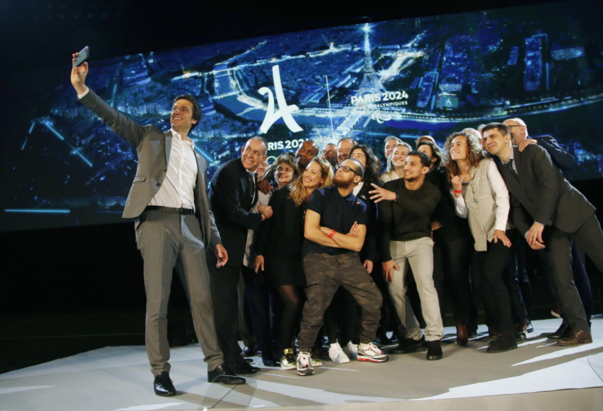 Paris 2024 Games’ chief Tony Estanguet, left, makes a selfie with all invited guests after a media conference at La Defense business district, outside Paris, Thursday, Feb. 21 , 2019. The organizers of the 2024 Paris Olympics want to add breakdancing to the games, which would be a first for the dance sport that came from the streets of New York. Also on Paris’ wish-list of events it wants to add to the program are climbing, surfing and skateboarding.