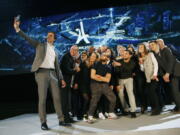 Paris 2024 Games’ chief Tony Estanguet, left, makes a selfie with all invited guests after a media conference at La Defense business district, outside Paris, Thursday, Feb. 21 , 2019. The organizers of the 2024 Paris Olympics want to add breakdancing to the games, which would be a first for the dance sport that came from the streets of New York. Also on Paris’ wish-list of events it wants to add to the program are climbing, surfing and skateboarding.