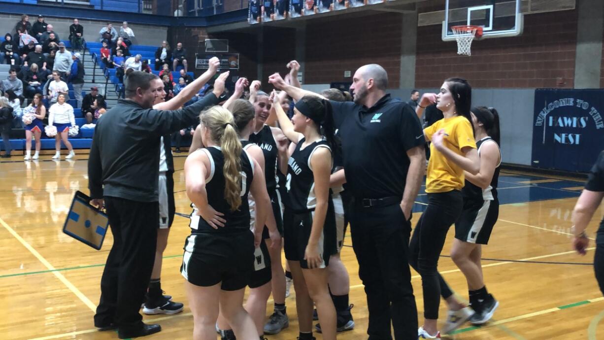 The Woodland girls basketball team cheers after a 64-43 2A district win over Ridgefield at Hockinson High School on Thursday.