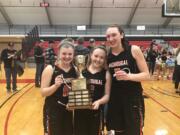 Washougal seniors, from left, Ashley Gibbons, Kiara Cross and Beyonce Bea pose with the district championship trophy.