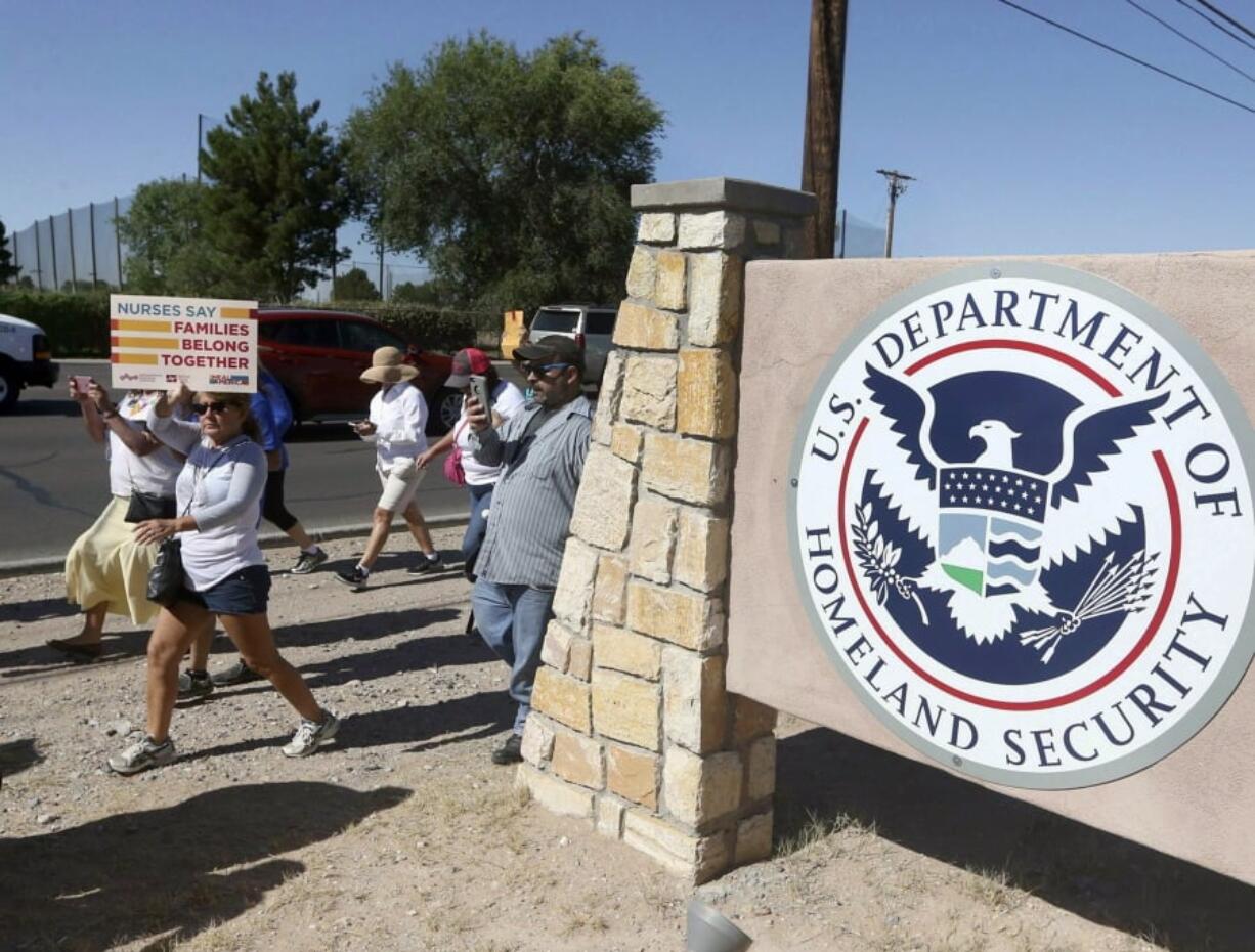 FILE - This June 2018 file photo shows protesters walking along Montana Avenue outside the El Paso Processing Center, in El Paso, Texas. The U.S. government has suddenly stopped force-feeding a group of men on a hunger strike inside a Texas immigration detention center, U.S. Immigration and Customs Enforcement said Thursday, Feb. 14, 2019. The dramatic reversal comes as public pressure was mounting on ICE to halt the practice, which involves feeding detainees through nasal tubes against their will.