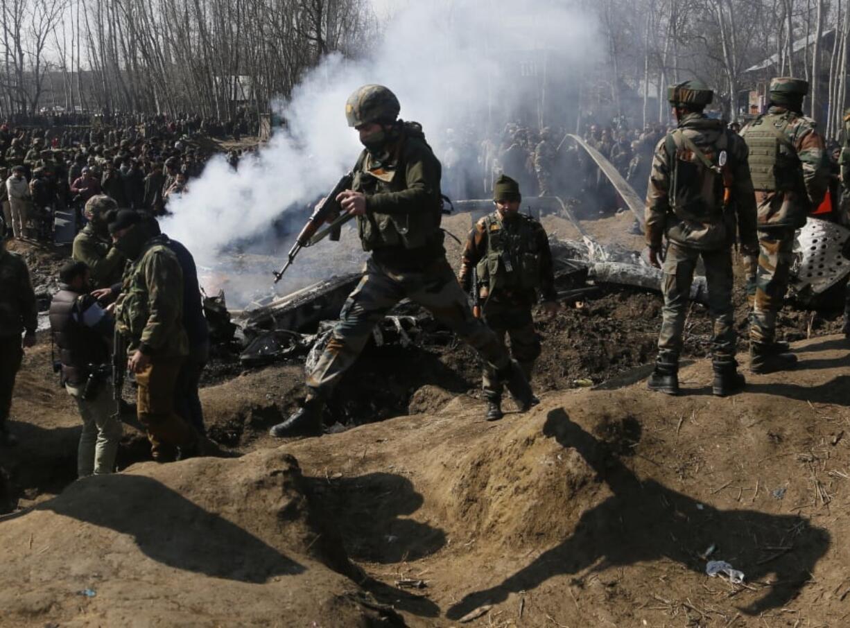 Indian army soldiers arrive near the wreckage of an Indian aircraft after it crashed in Budgam area, outskirts of Srinagar, Indian controlled Kashmir, Wednesday, Feb.27, 2019.