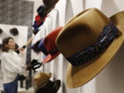 A woman looks at hats Jan. 16 in a Borsalino store in downtown Milan, Italy. If the traditional Italian hat-maker Borsalino was once synonymous with the fedora, its new private equity owners want to imbue the brand with cachet that extends to couture, sportswear and streetwear for women and Millennials — without alienating its classic customers and the silhouette that helped shape the rough-and-tumble images of Robert Redford, Frank Sinatra and, perhaps no one more than, Humphrey Bogart.