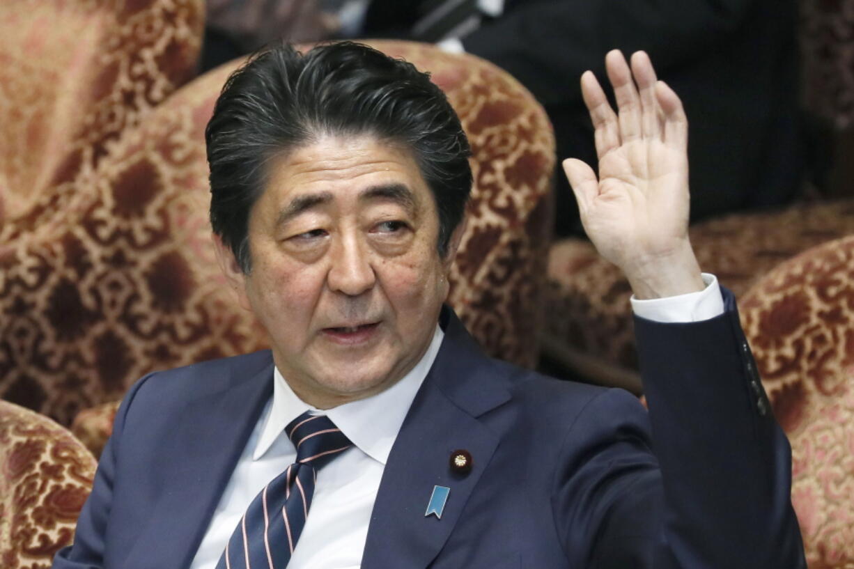 Japanese Prime Minister Shinzo Abe raises his hand Monday during a parliamentary session at the Lower House in Tokyo. Abe and his chief spokesman have declined to say if Abe nominated President Donald Trump for a Nobel Peace prize.