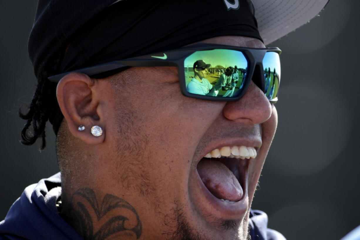 Seattle Mariners starting pitcher Felix Hernandez (34) laughs with teammates during spring training baseball practice Tuesday, Feb. 12, 2019, in Peoria, Ariz.