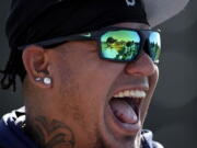 Seattle Mariners starting pitcher Felix Hernandez (34) laughs with teammates during spring training baseball practice Tuesday, Feb. 12, 2019, in Peoria, Ariz.