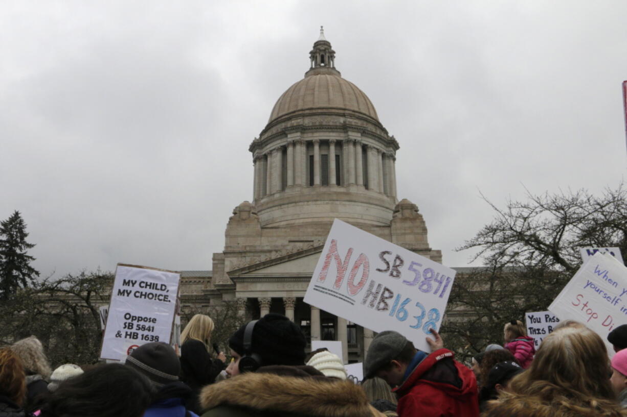 Opponents of efforts to remove philosophical exemptions from school-vaccine requirements rally outside the Washington Capitol on Wednesday in Olympia.