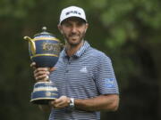 U.S. golfer Dustin Johnson poses with his Mexico Championship trophy at the Chapultepec Golf Club in Mexico City, Sunday, Feb. 24, 2019.