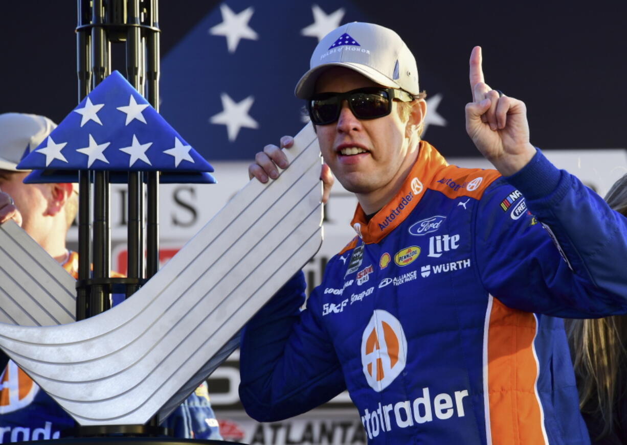 Brad Keselowski poses with the trophy during a NASCAR Monster Energy NASCAR Cup Series auto race at Atlanta Motor Speedway, Sunday, Feb. 24, 2019, in Hampton, Ga.