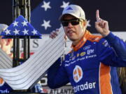 Brad Keselowski poses with the trophy during a NASCAR Monster Energy NASCAR Cup Series auto race at Atlanta Motor Speedway, Sunday, Feb. 24, 2019, in Hampton, Ga.